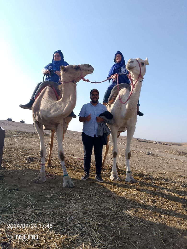 Ayoub hosting guests on a camel experience
